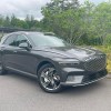 The 2023 Genesis Electrifed GV70 parked near plants