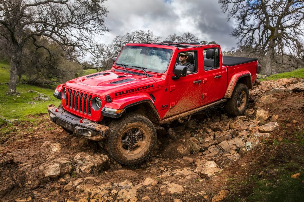 The Jeep Gladiator crawling over rocks and mud