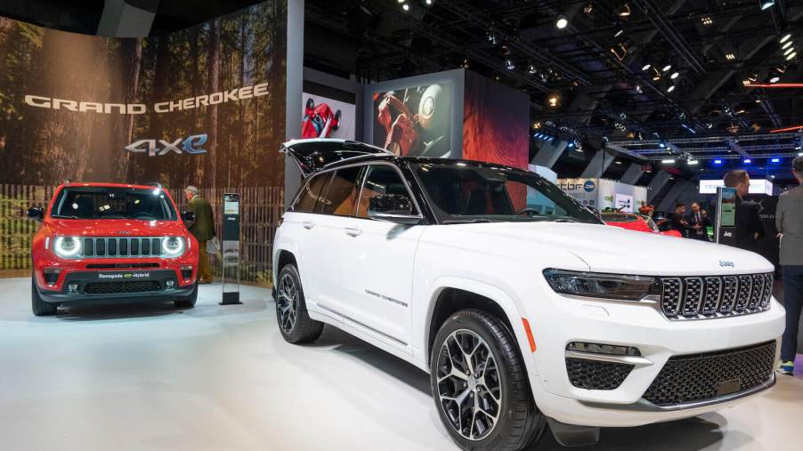 White Jeep Cherokee 4Xe and Jeep Renegade 4Xe SUV cars at Brussels Expo