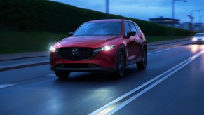 A red 2023 Mazda CX-5 2.5 Turbo on the road in the evening.