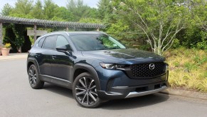The 2023 Mazda CX-50 parked near foliage
