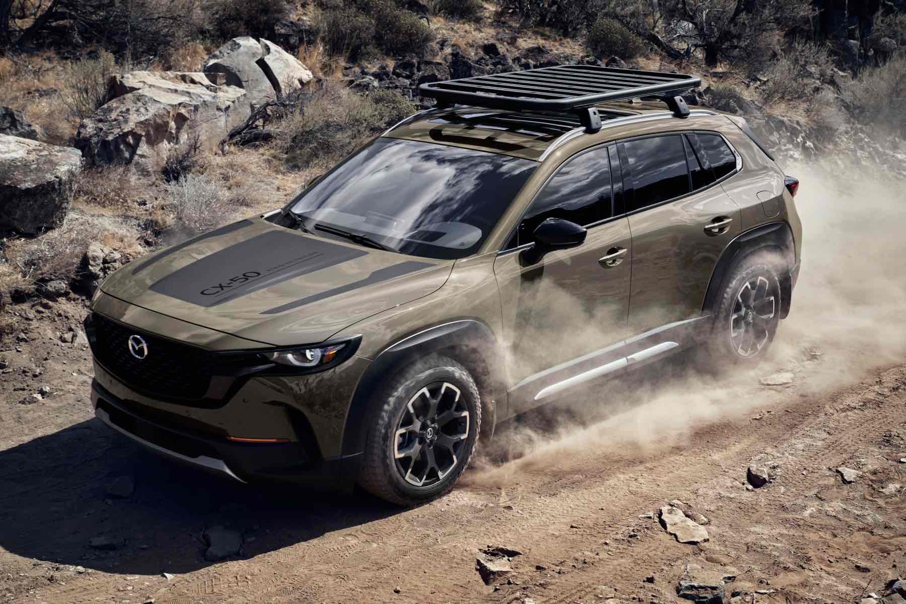 The 2023 Mazda CX-50 Meridian SUV drives on an off-road trail.
