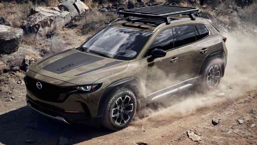 The 2023 Mazda CX-50 Meridian SUV drives on an off-road trail.