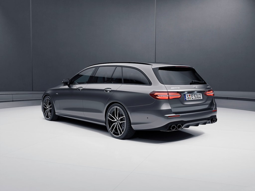 A Gray 2023 Mercedes E-Class Wagon parked in a studio looking from the rear of the car