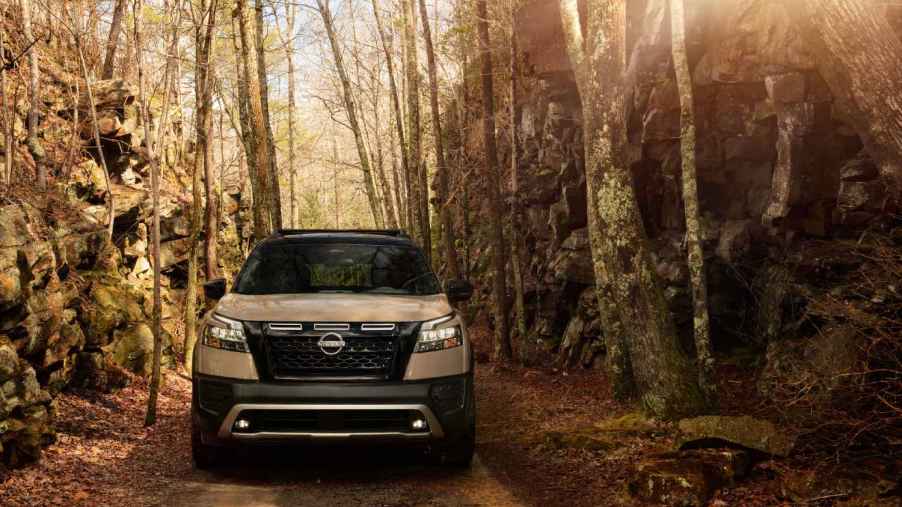 A 2023 Nissan Pathfinder driving in the woods.