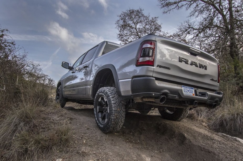 The back tires of a Ram 1500 rebel on an off-road trail.