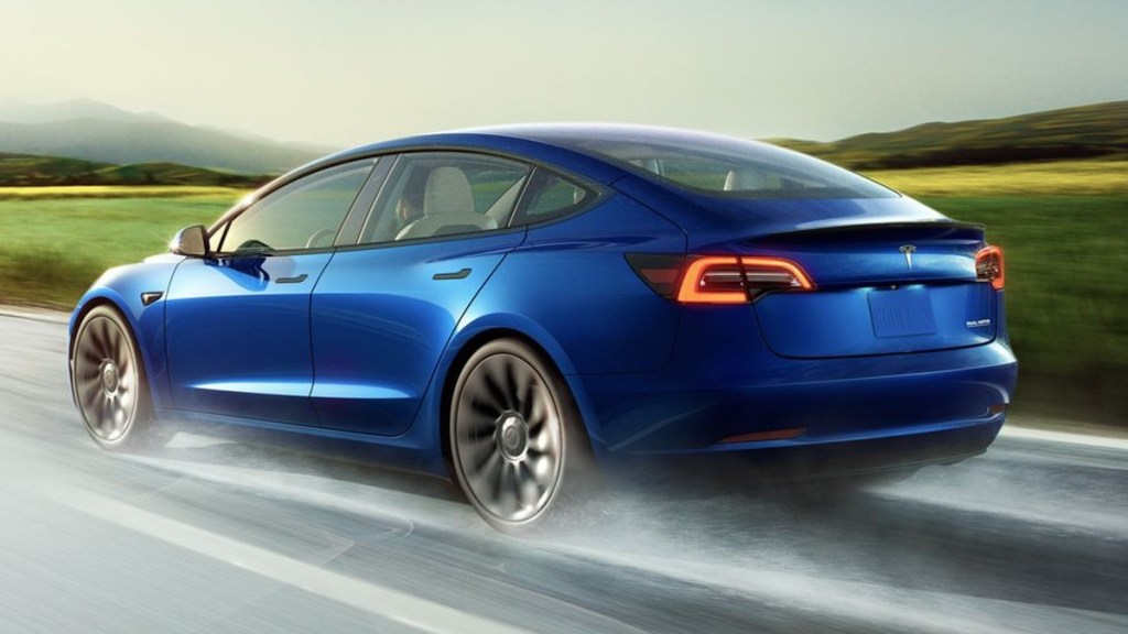 Blue 2023 Tesla Model 3 driving on a road - Should this EV make more noise