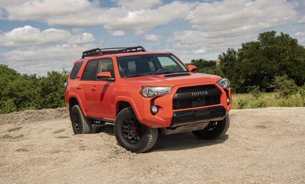 A 2023 Toyota 4Runner TRD Pro with an organge Solar Octane paint job parked on gravel