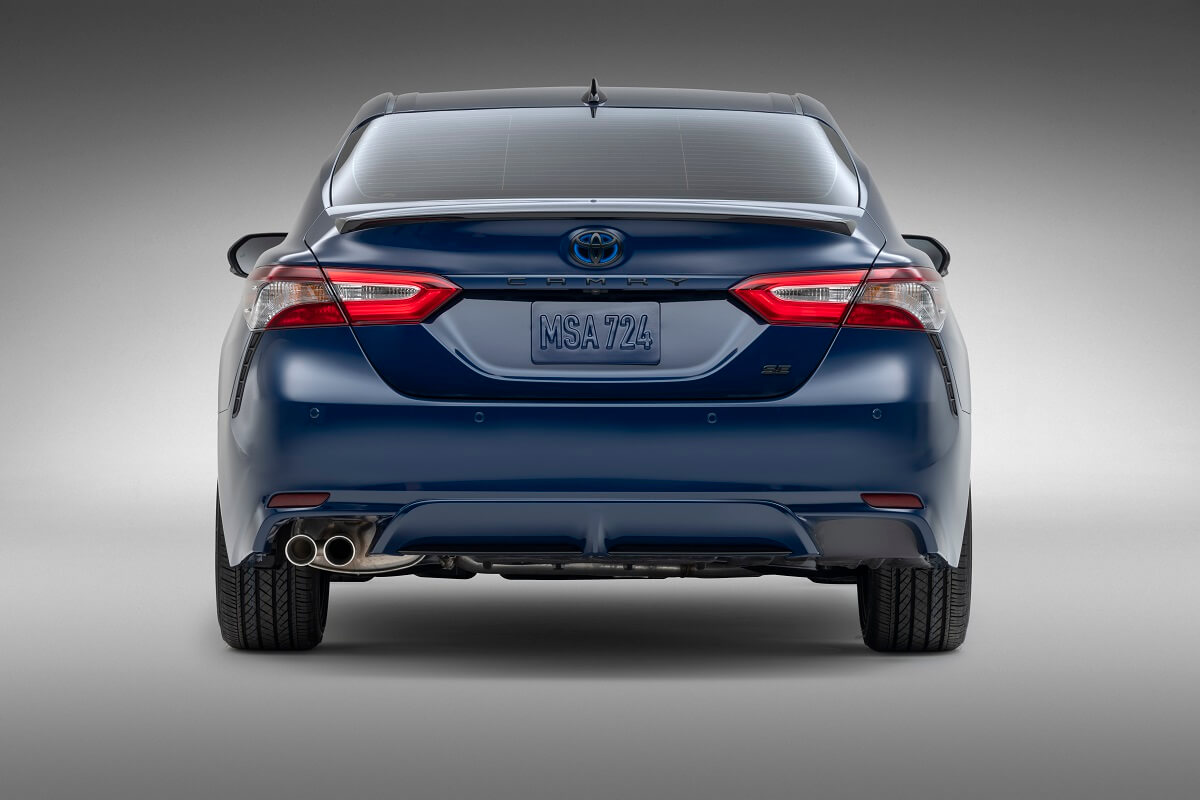 A blue Toyota Camry Hybrid shows off its rear-end styling.
