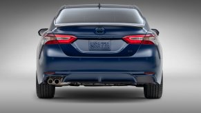 A blue Toyota Camry Hybrid shows off its rear-end styling.