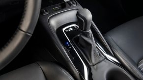 A Toyota car model shows off its Eco button and fuel economy drive modes.