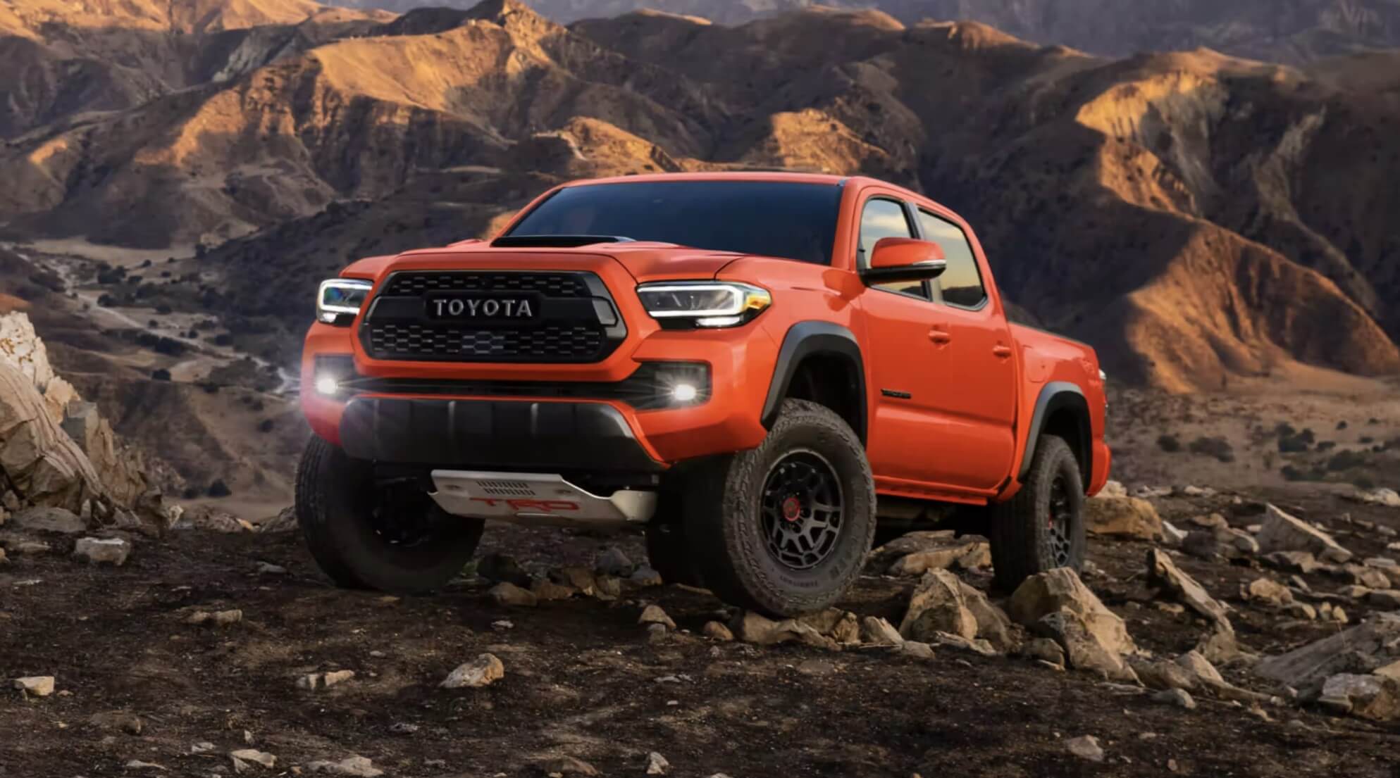 The 2023 Toyota Tacoma off-roading over rocky terrain.