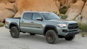 A 2023 Toyota Tacoma pickup truck driving in the mountains. This is one of the best Toyota Tacoma model years.