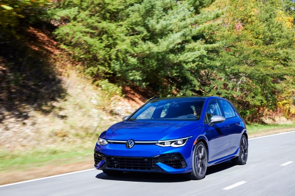 A 2023 Volkswagen Golf R blasts around a mountain road faster than a Ford Mustang GT.