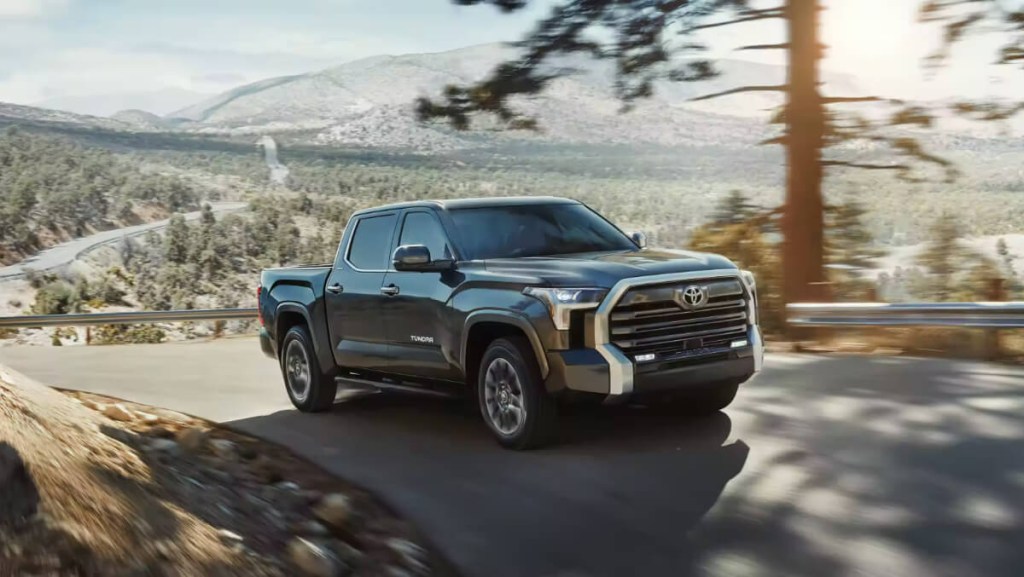 A 2023 Toyota Tundra full-size truck is driving down the road.