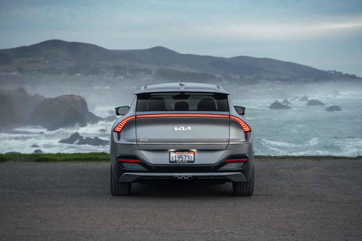 The 2023 Kia EV6 in silver looking over a cliff on a cloudy day.