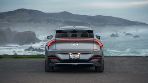 The 2023 Kia EV6 in silver looking over a cliff on a cloudy day.