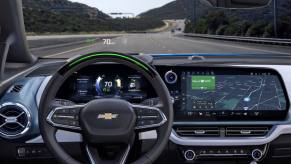Driver's seat view of a 2024 Chevy Equinox EV 3LT model with Super Cruise active and operating on a highway