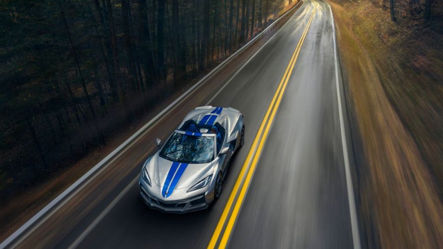A 2024 Chevy Corvette E-Ray 3LZ Convertible hybrid sports car in Silver Flare color with an Electric Blue stripe