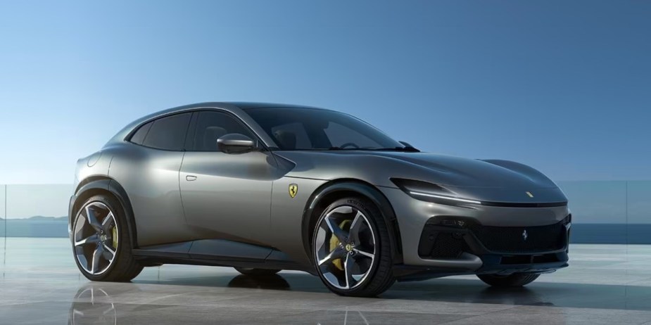 A gray Ferrari Purosangue luxury performance SUV is parked. 