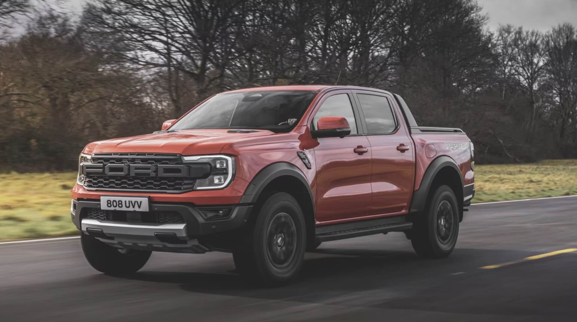 A 2024 Ford Ranger Raptor driving down an open road.