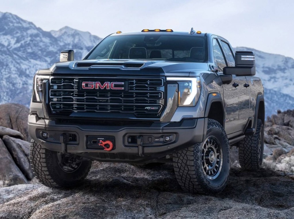 The 2024 GMC Sierra 2500HD AT4X AEV Edition off-roading over rocks