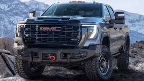 The 2024 GMC Sierra 2500HD AT4X AEV Edition off-roading over rocks