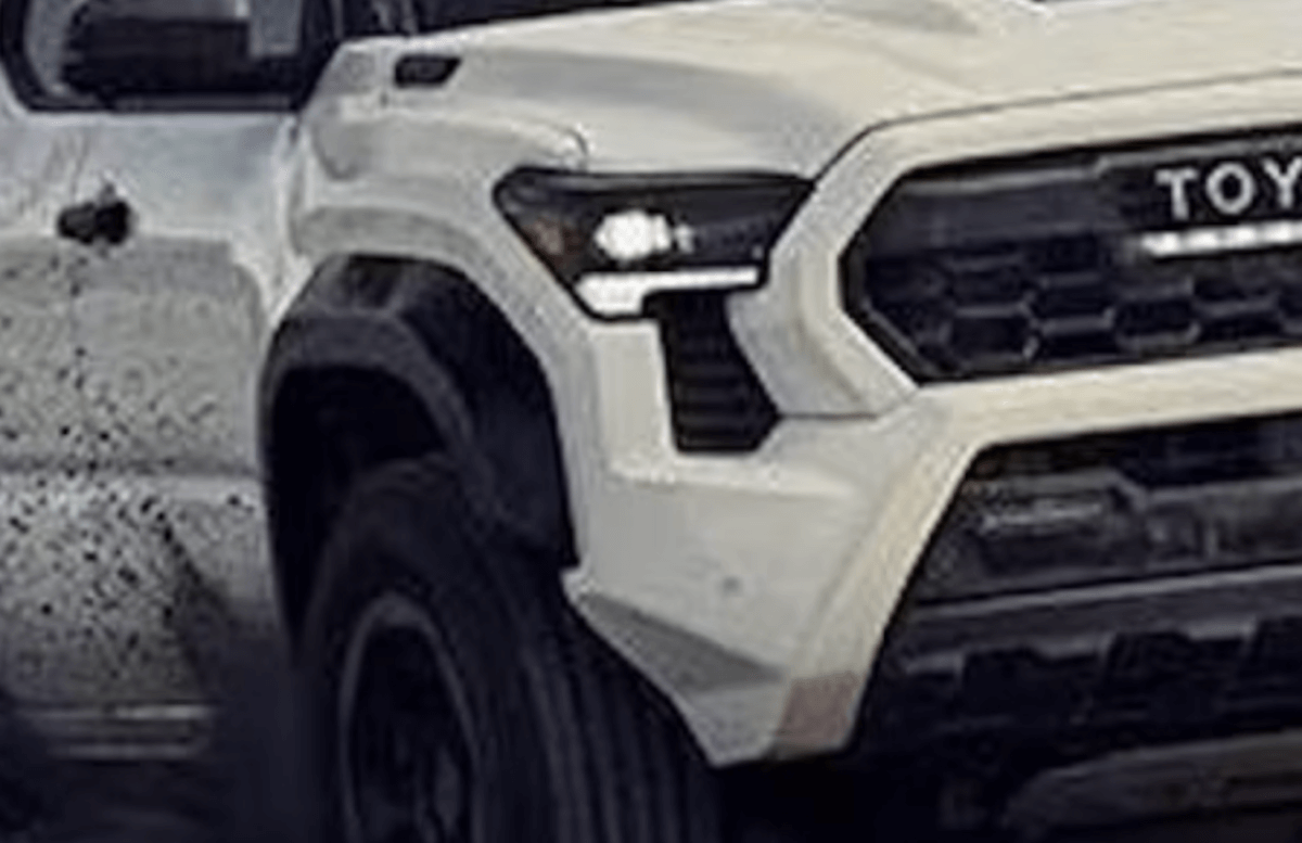 White 2024 Toyota Tacoma off-road throwing dirt