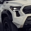 White 2024 Toyota Tacoma off-road throwing dirt