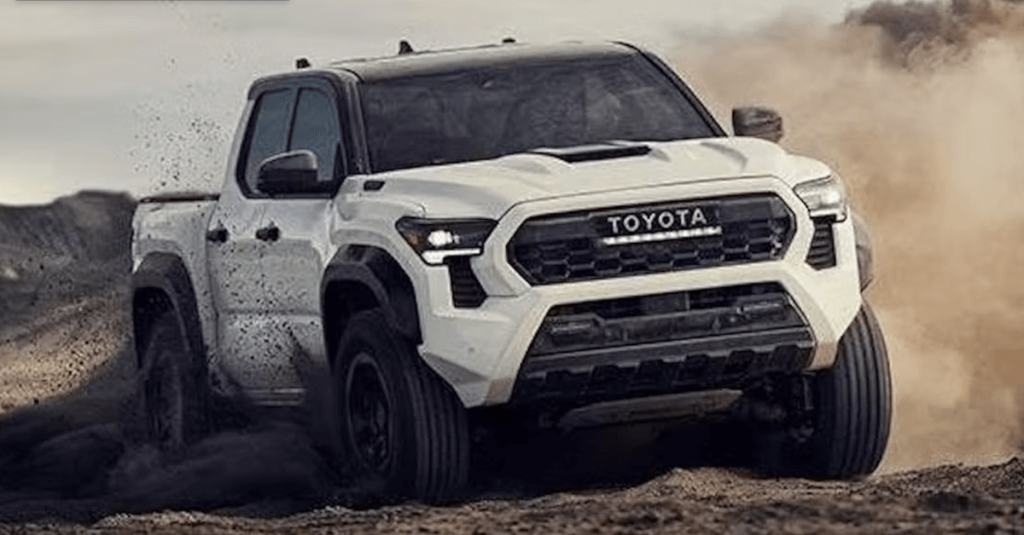 White 2024 Toyota Tacoma kicking up dirt