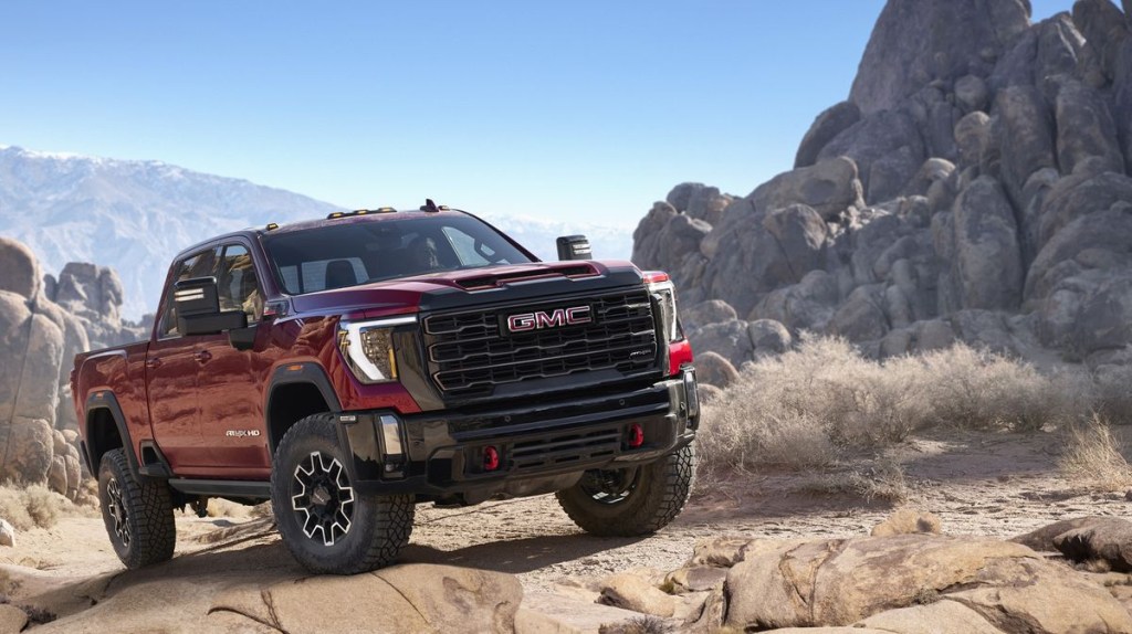 The 2024 GMC Sierra 2500HD AT4X off-roading in sand