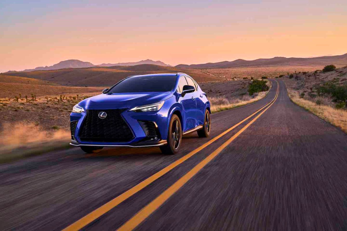 THe 2024 Lexus NX 450h+ in blue on a desert road at twilight.