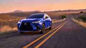 THe 2024 Lexus NX 450h+ in blue on a desert road at twilight.