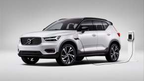 A silver 2023 Volvo XC40 Recharge Plug-in Hybrid plugged in to charge.