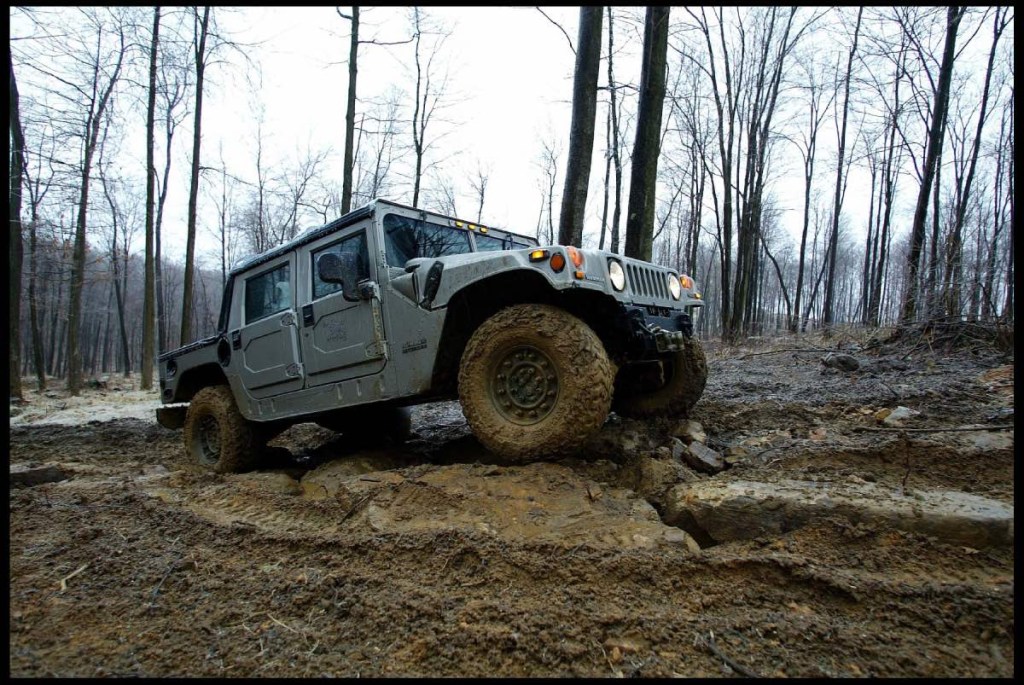 A Hummer off-road vehicle shows how to use a four-wheel drive system on a muddy off-road course. 