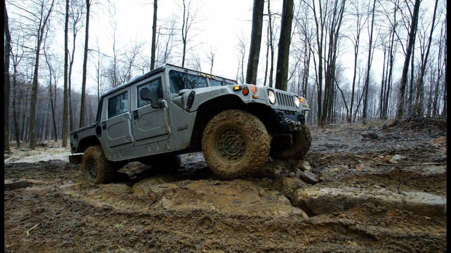A Hummer off-road vehicle shows how to use a four-wheel drive system on a muddy off-road course.