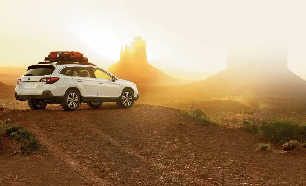 A white 2019 Subaru Outback looks out over Monument Valley at dusk. The Subaru Outback has plenty of strengths and weaknesses. 