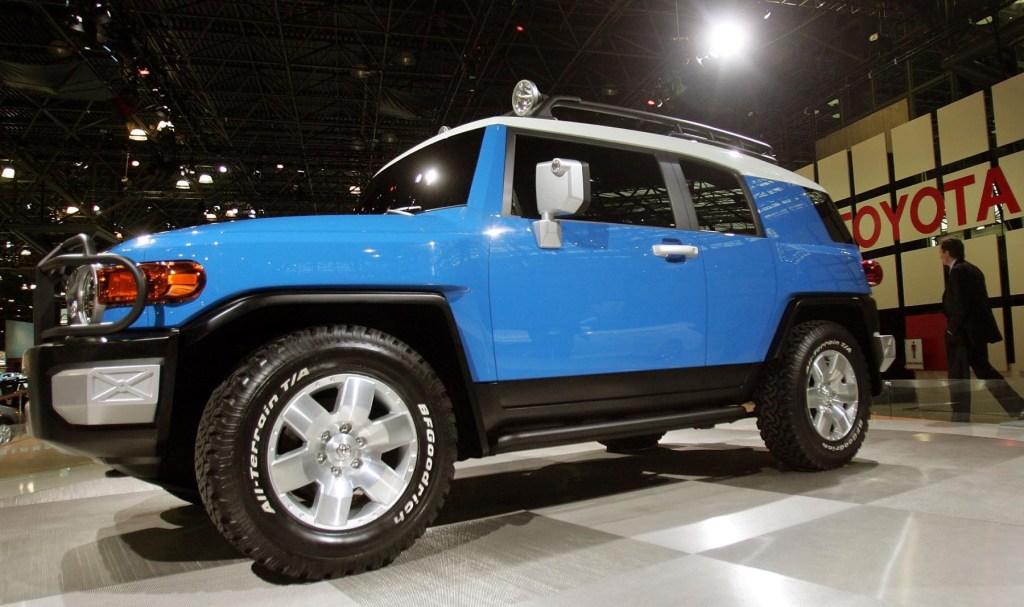 A blue Toyota FJ Cruiser sits on display at an auto show. 