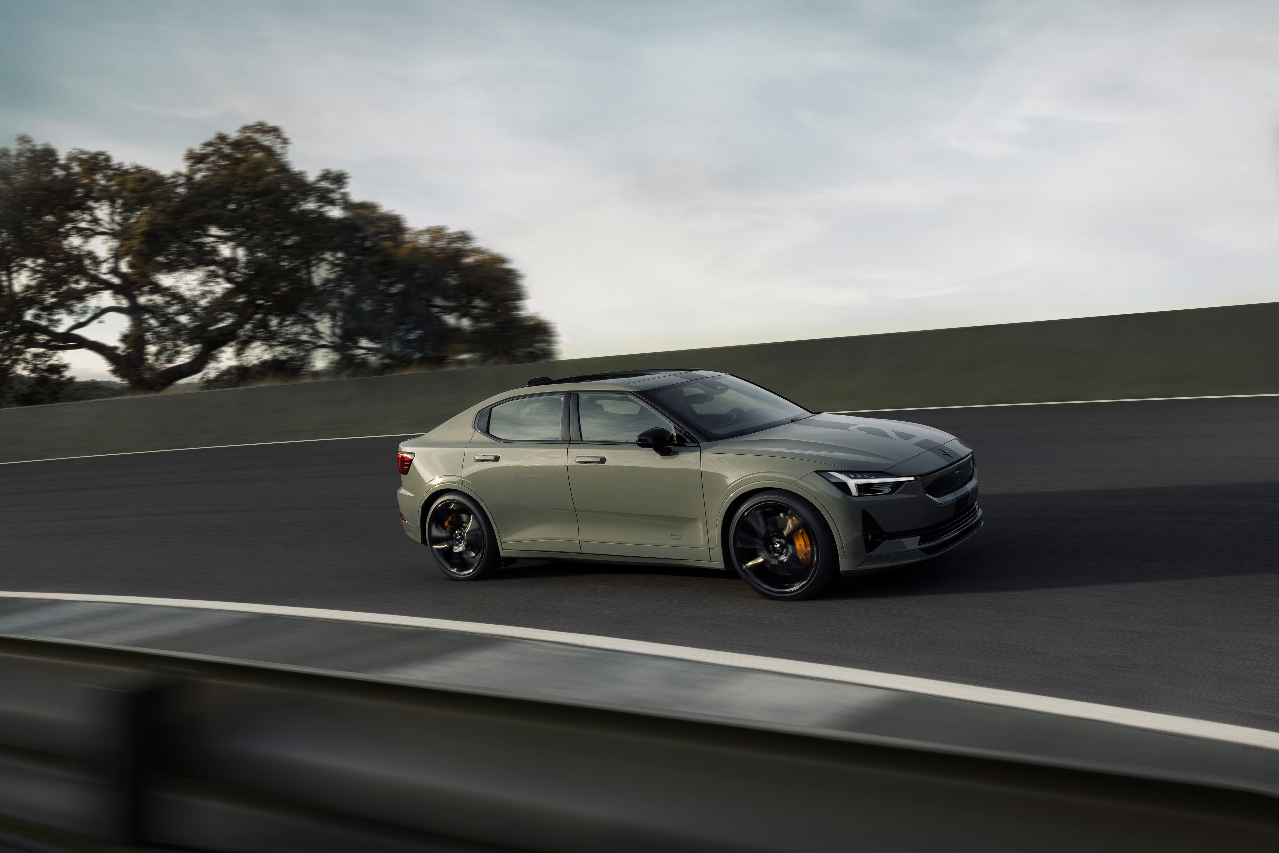 A grey Polestar 2 on a road at high speed 