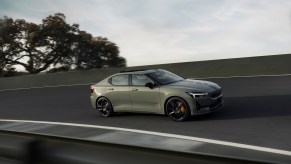 A grey Polestar 2 on a road at high speed