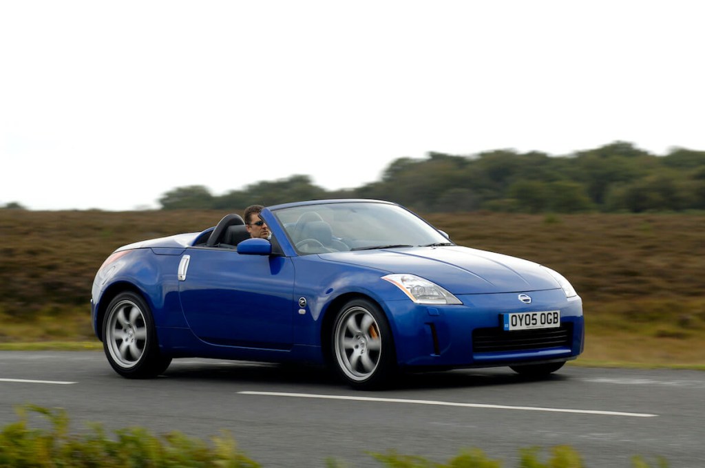 The front view of a Nissan 350Z driving down a road.
