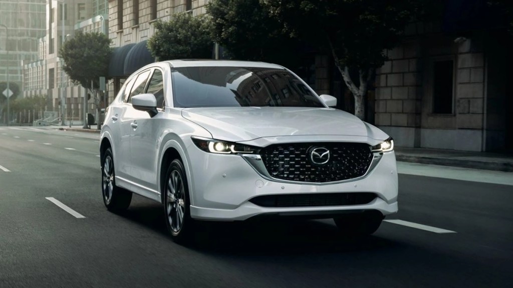 Affordable 2023 Mazda CX-5, best new compact SUV that costs $26K, driving on a street