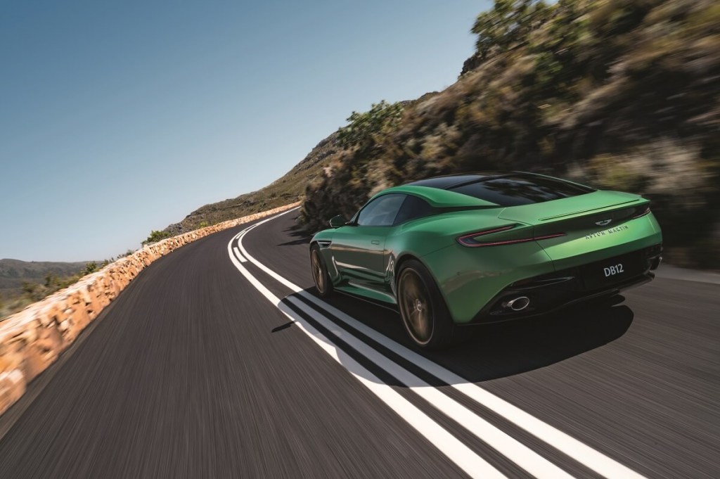 The new Aston Martin DB12 'Super Tourer' corners on a mountain road.