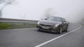 A silver BMW Shooting Brake Concept driving on a two lane road