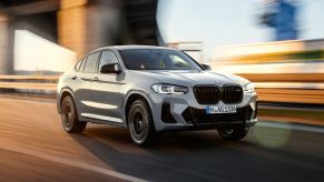 A BMW X4 driving on a highway.