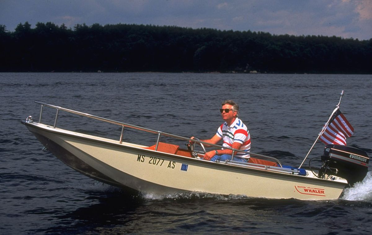 A man driving a small Boston Whaler boat.