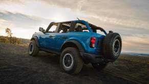 A blue 2023 Ford Bronco driving off-road.