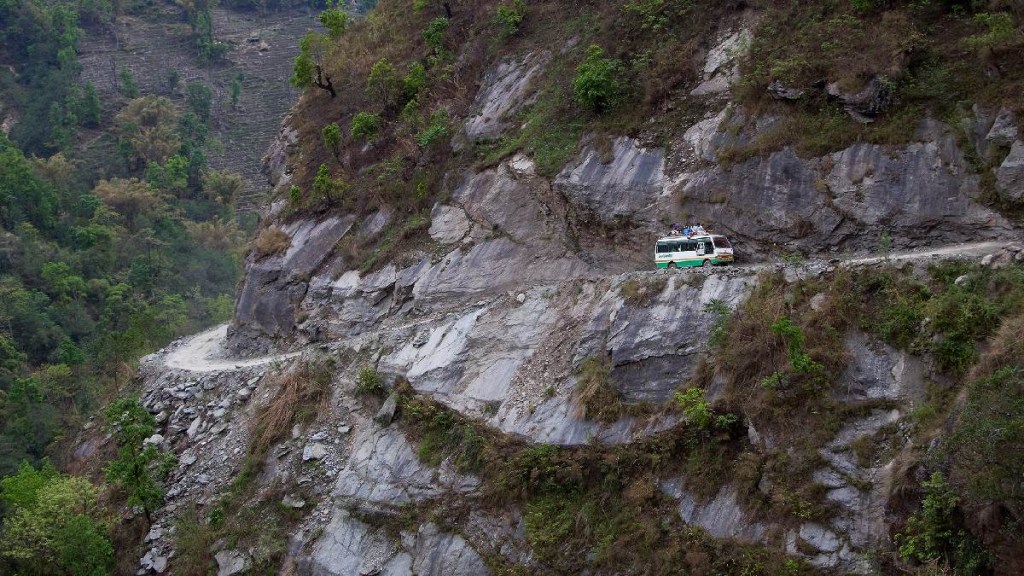 Bus driving on mountain road in Nepal
