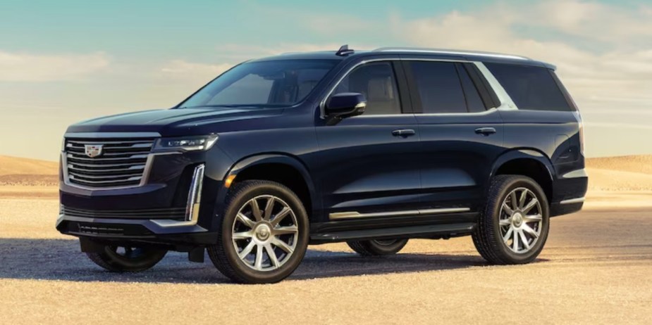 A black 2023 Cadillac Escalade full-size SUV is parked. 