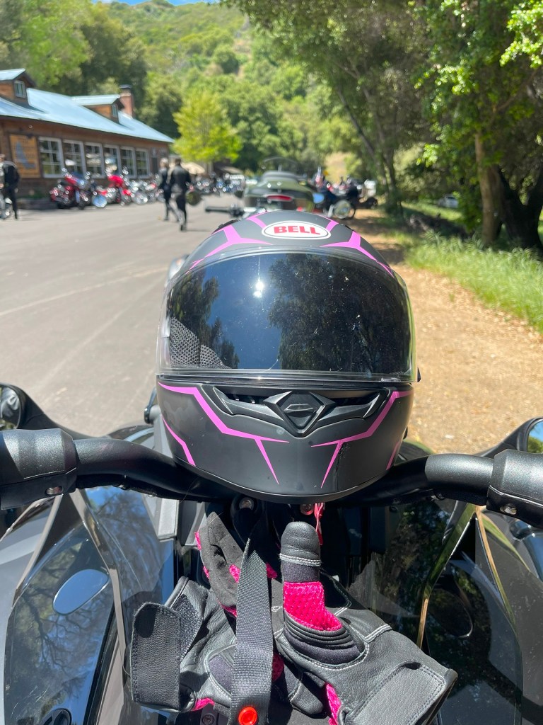 A motorcycle and gloves for the 2023 Can-Am Ryker